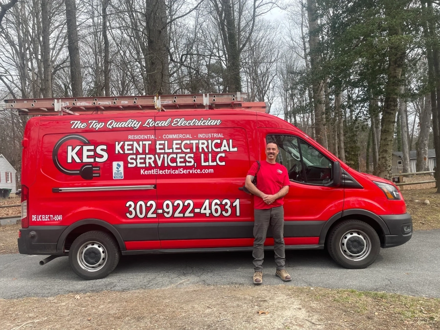 A man standing in front of a red van.