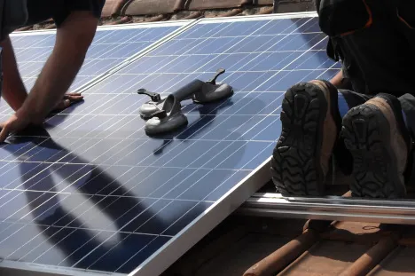 A person is working on the solar panel.